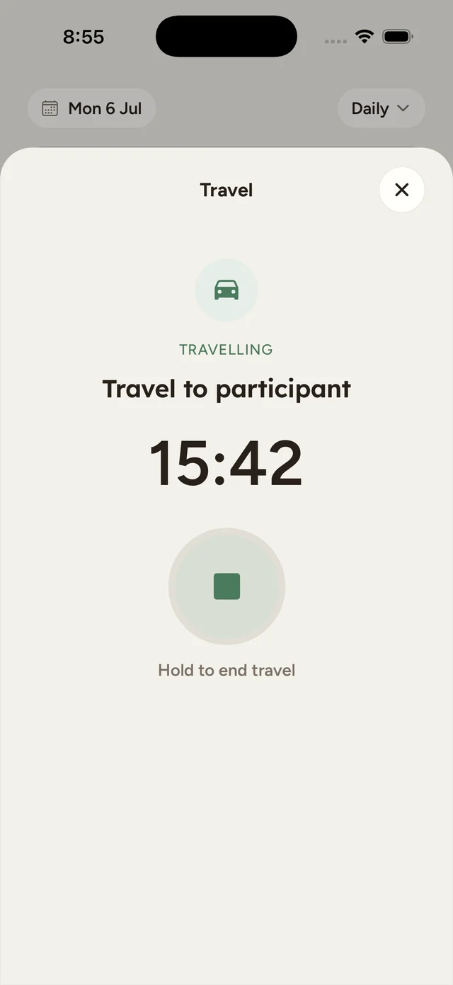 The focused travel screen showing TRAVELLING, the leg name Travel to participant, a timer counting up, and a Hold to end travel button.